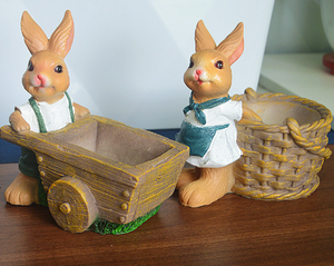 A pair of brown rabbit flower pots