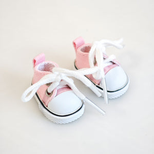 A pair of pink canvas shoes