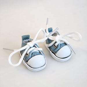 A pair of denim blue canvas shoes