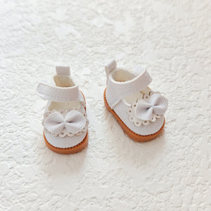 A pair of white princess shoes