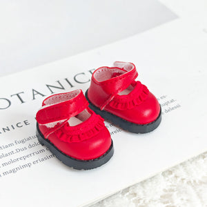A pair of lace red leather shoes