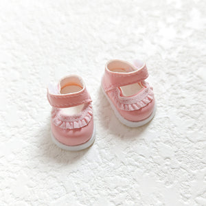 A pair of lace pink leather shoes
