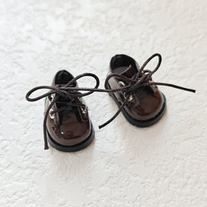 A pair of lace up brown leather shoes