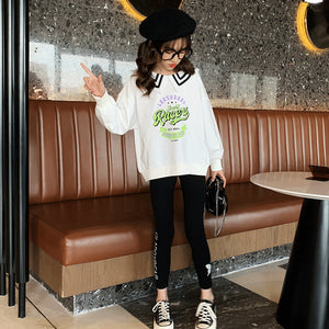 White sweater and black pants